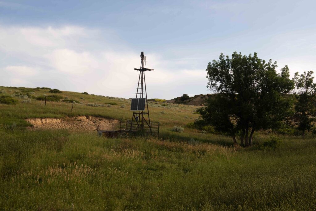 Old windmill tower now holding up solar panels.